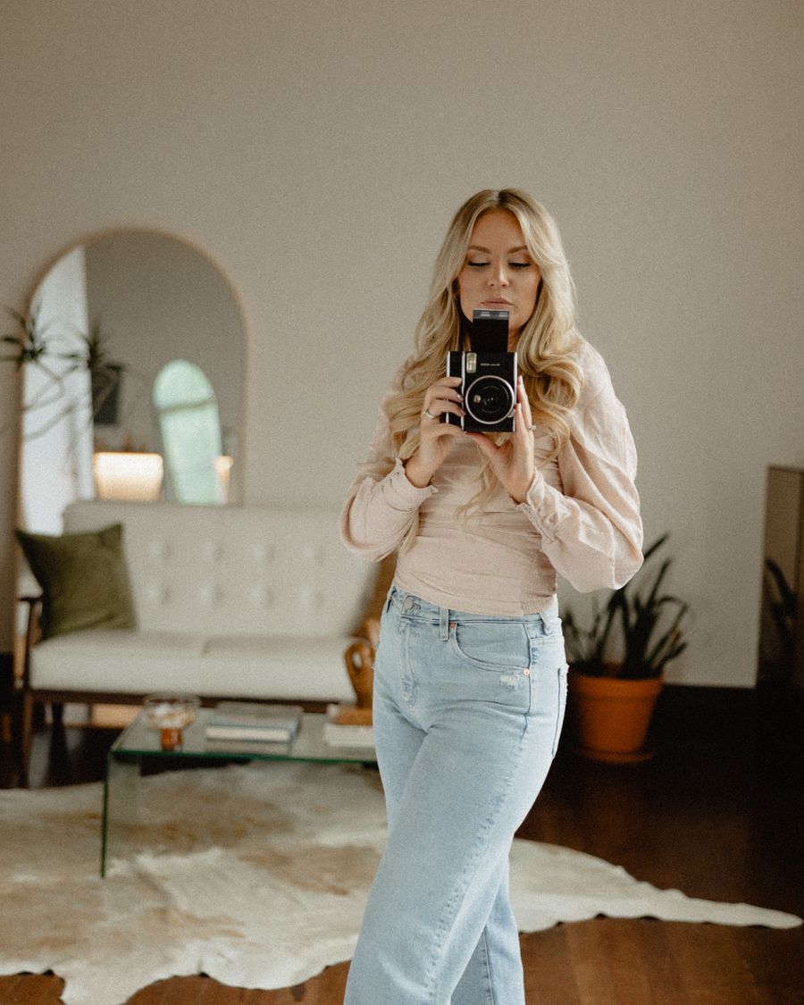 Kiana holding a camera in a bright studio