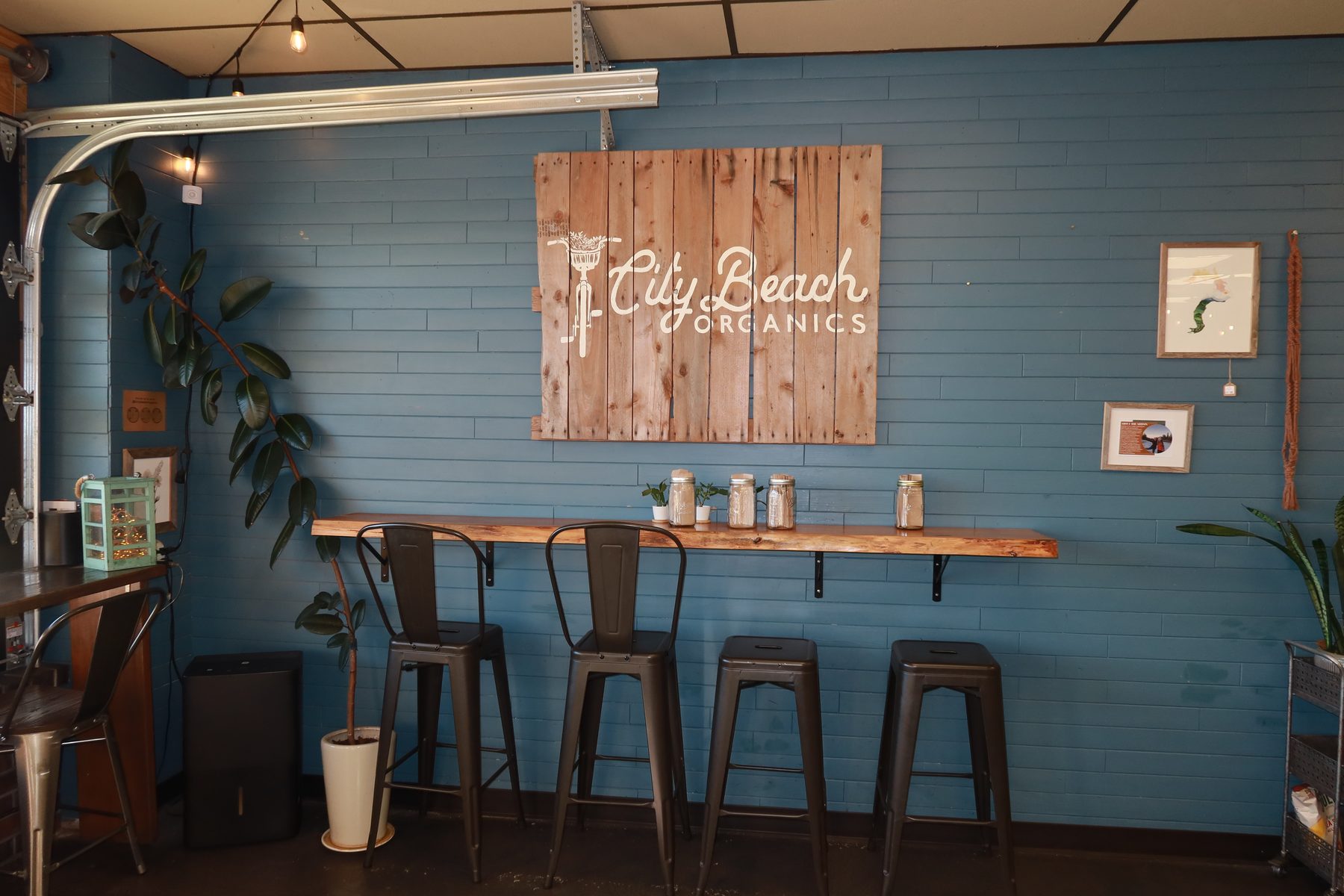 Inside City Beach Organics with its blue wall and wooden sign