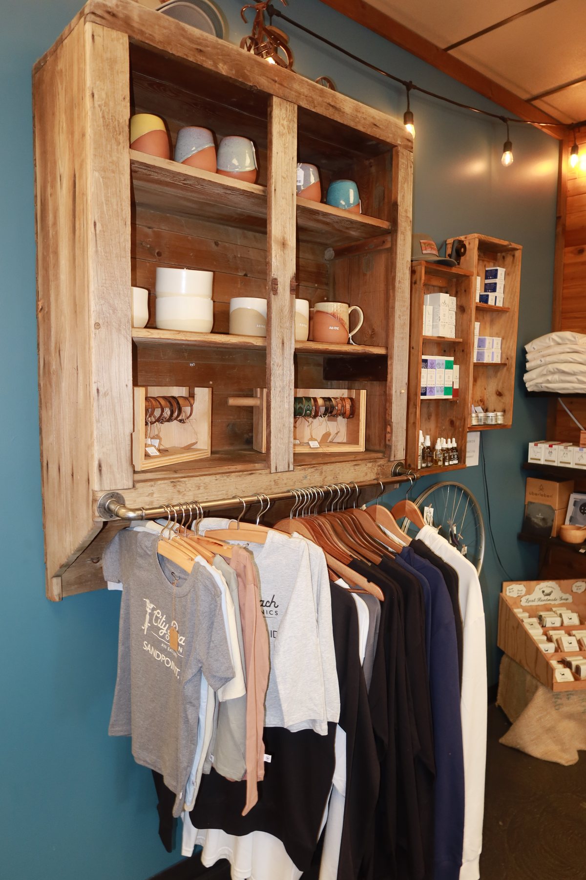 Shelves of mugs and Sandpoint apparel in the City Beach Organics shop