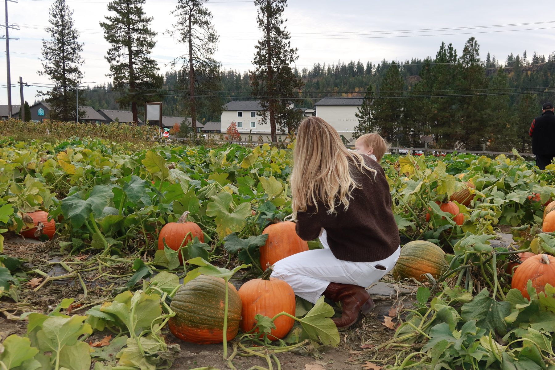 Kiana and our daughter sitting among pumpkins in the patch