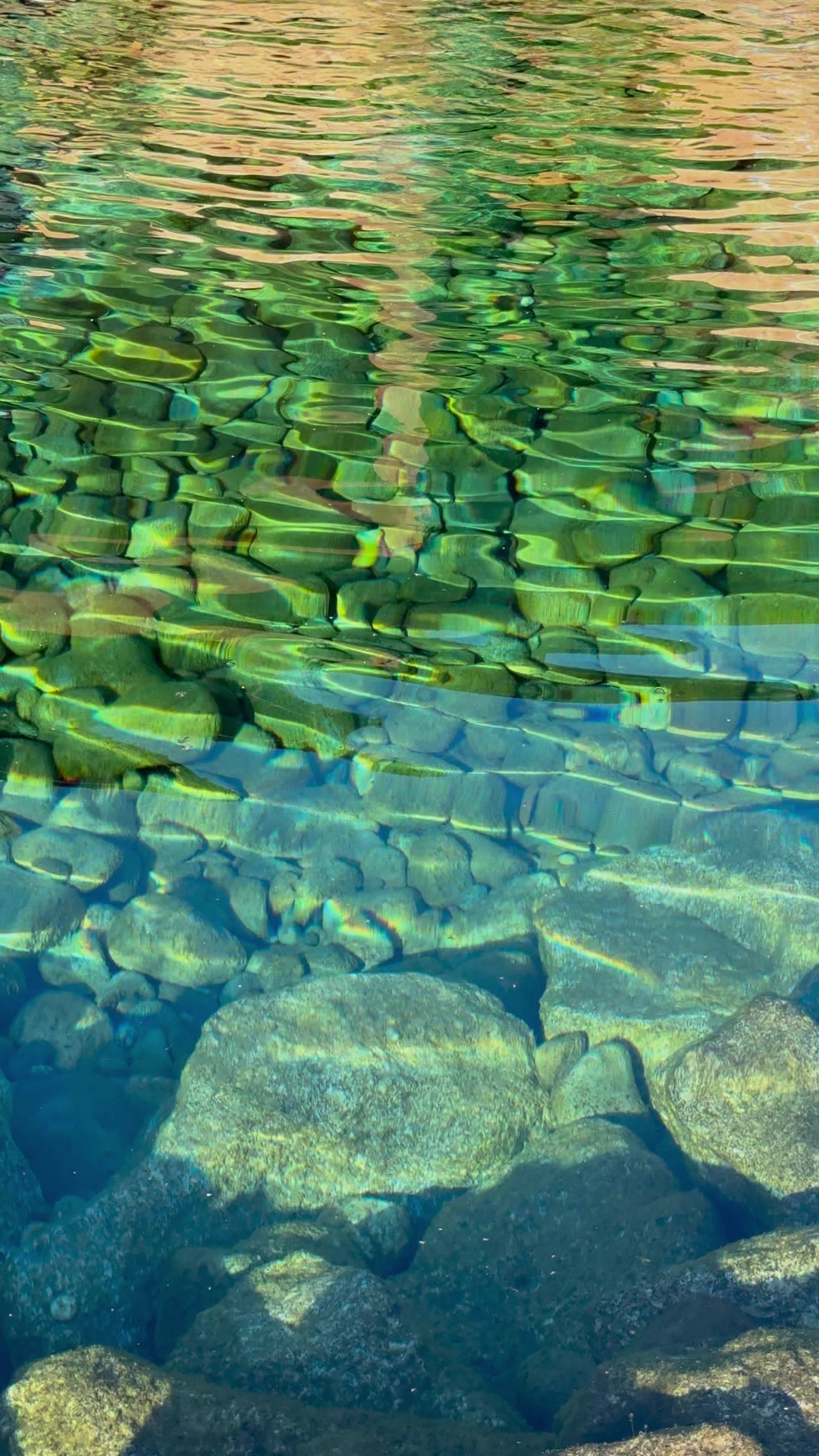 Crystal-clear water over the rocks in the cold plunge