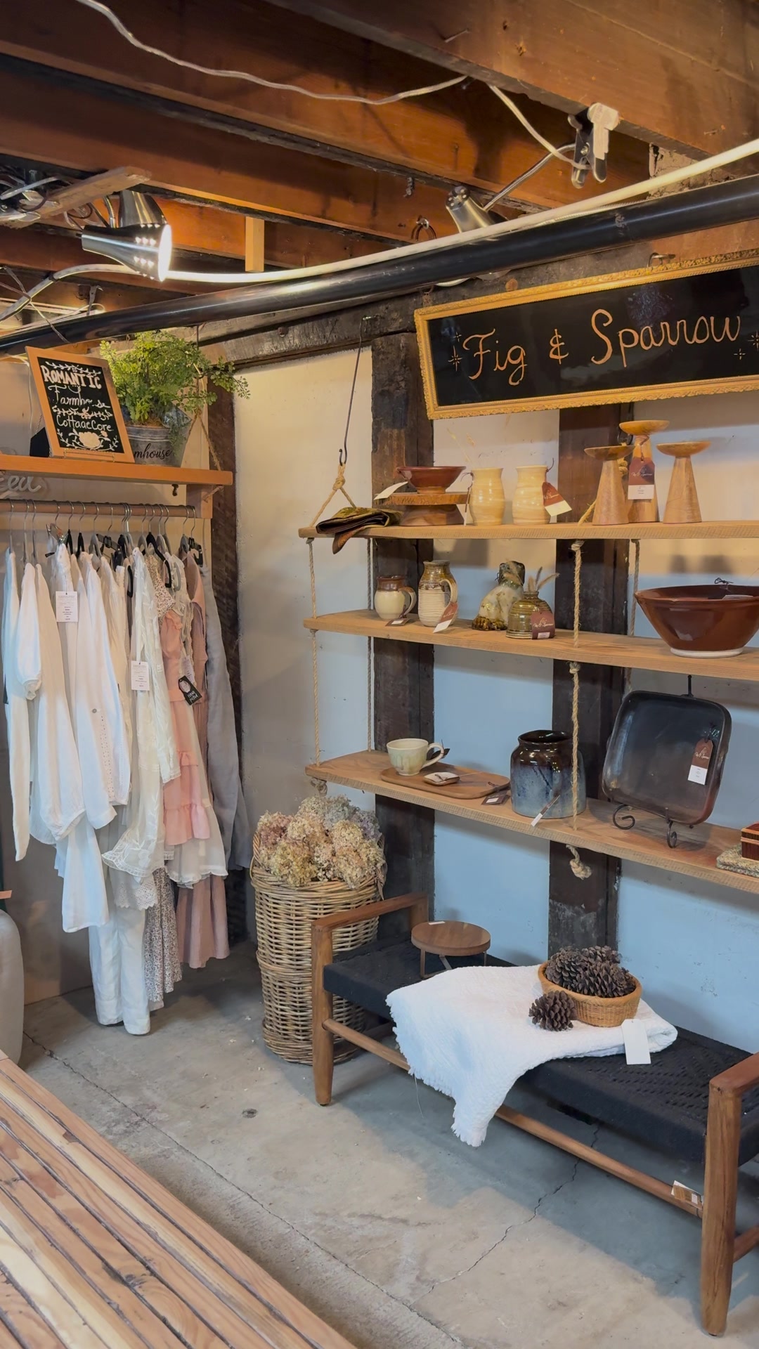 Racks of dresses and handmade pottery at Fig & Sparrow in the shops downstairs