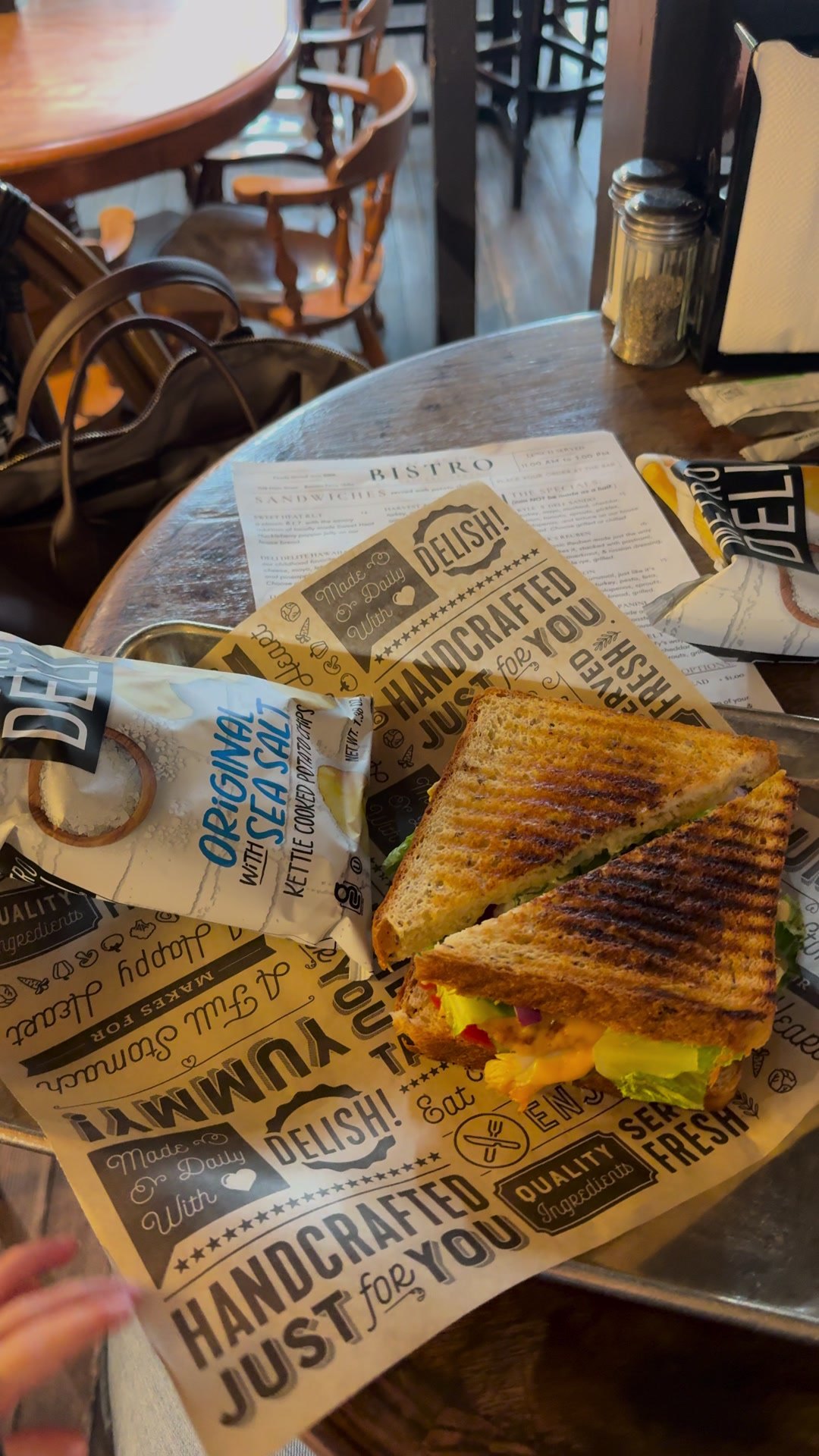 A grilled sandwich wrapped in paper