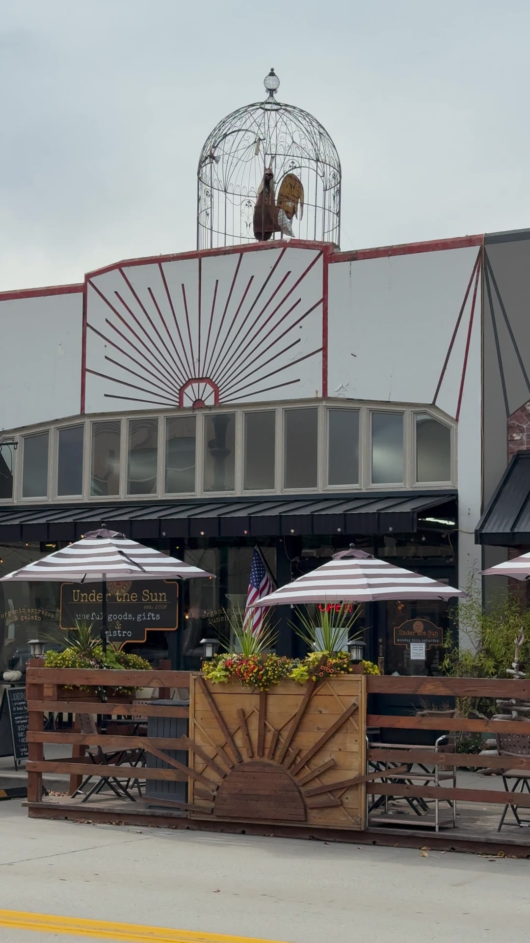 The Under the Sun storefront with its sunburst facade and patio